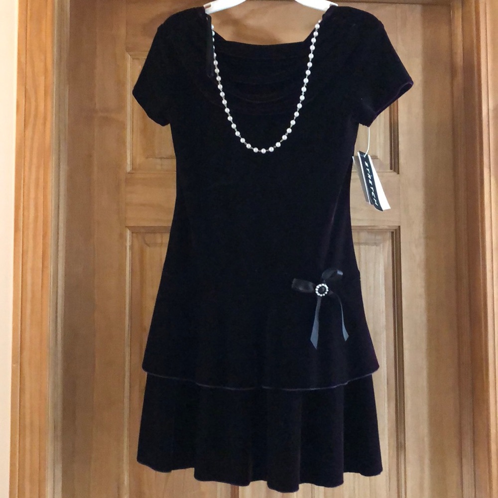 A dark purple children’s dress.